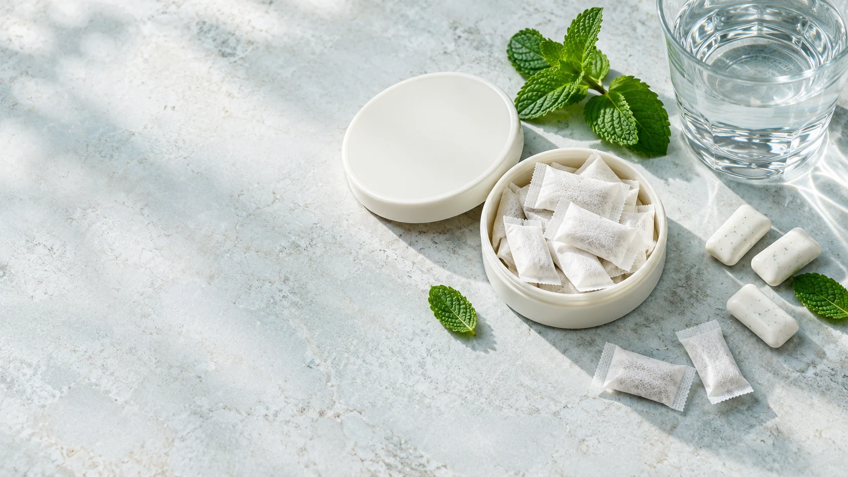 Illustrative white oral care pouches with a portable can and water